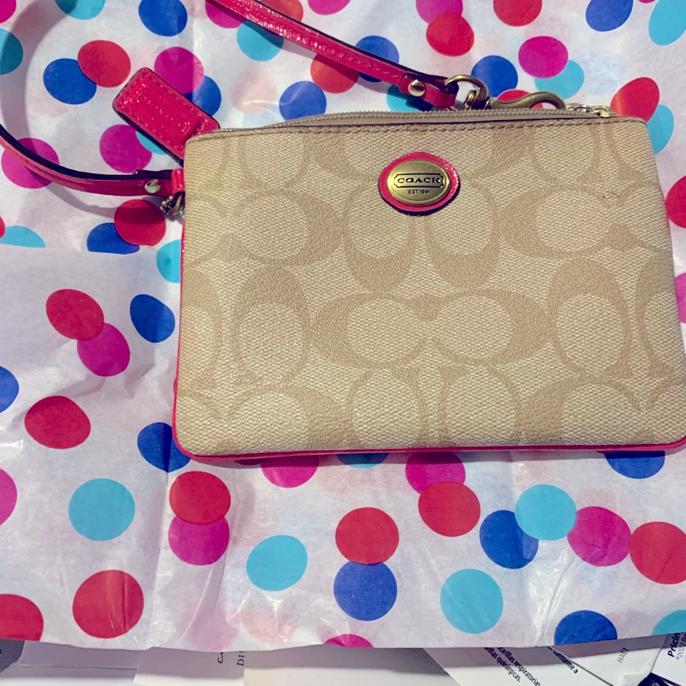 Coach signature wristlet with Pink trim. Very good condition.Like New